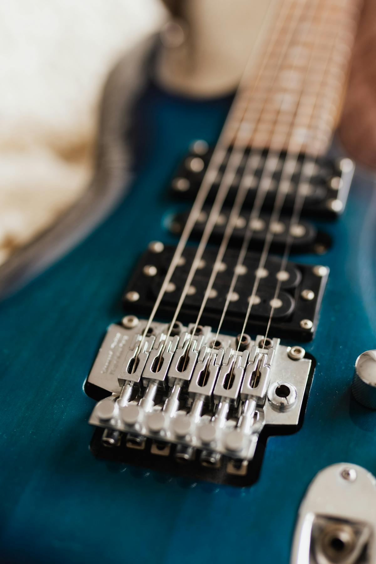 Close-up of electric guitar strings over pickups and bridge